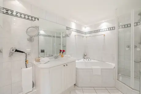 Elegantes Badezimmer im Hotel Stadt Hamburg mit Whirlpool und modernen Annehmlichkeiten.