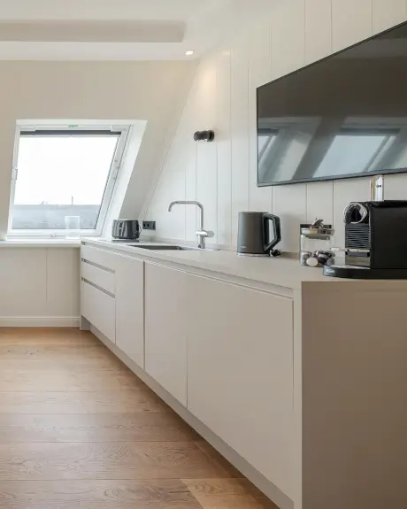 Moderne Hotelküche mit Kabinett, Fernseher, Wasserkocher und Kaffeemaschine im Hotel Stadt Hamburg, Sylt.