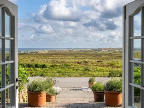Blick durch offene Türen auf die hügelige Landschaft von Kampen, Sylt.